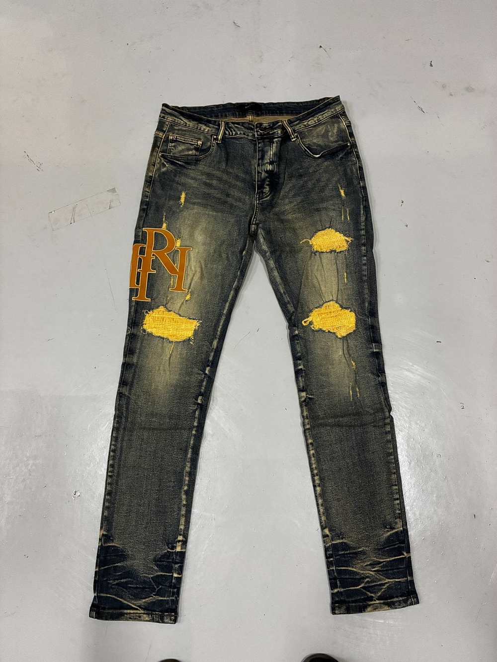 AMIRI Black Distressed Skinny Jeans with Yellow Patch Accents